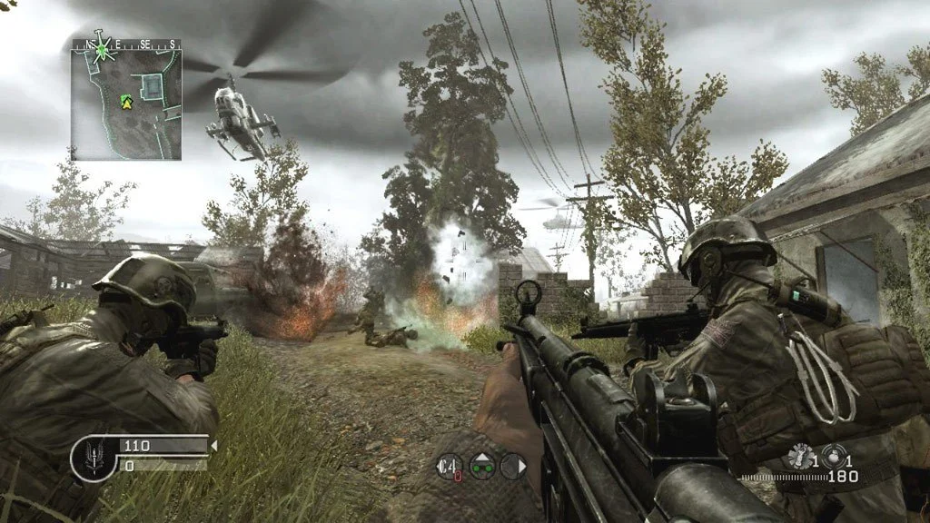 Over-the-rifle view on a rutted village lane, two Marines, blast, chopper, HUD showing 110 rounds