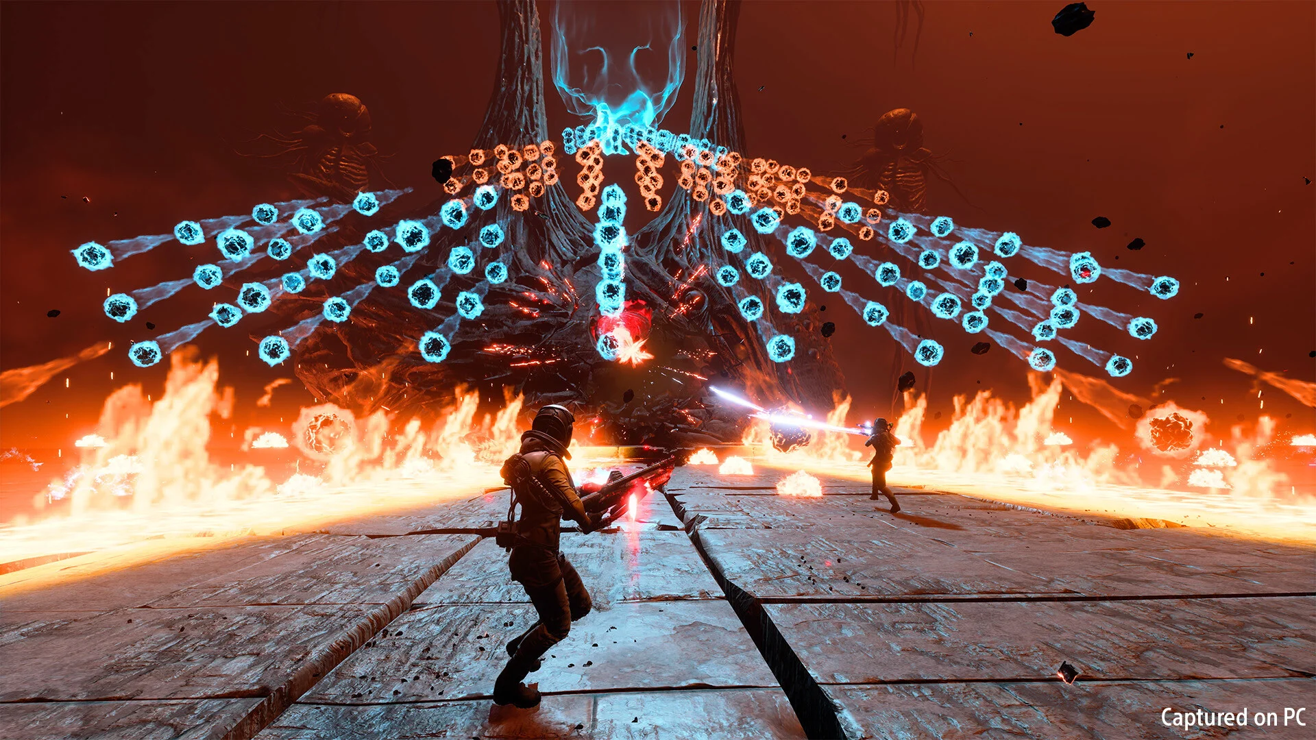 Two astronauts face a boss spraying blue hex-shot patterns over a burning floor