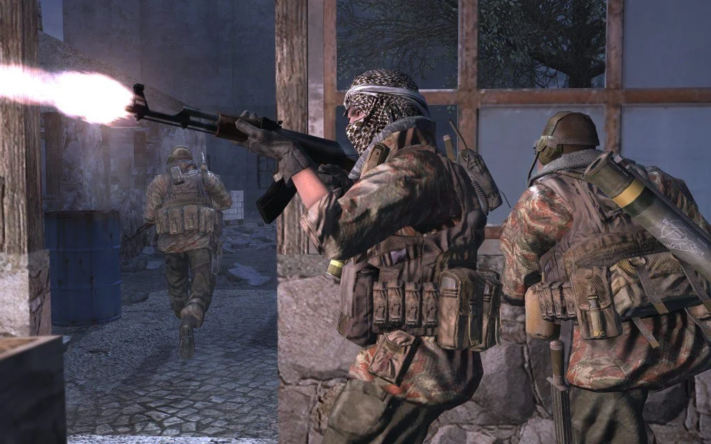 Night alley: keffiyeh fighter firing an AK, teammate with RPG tube, third running past a blue barrel
